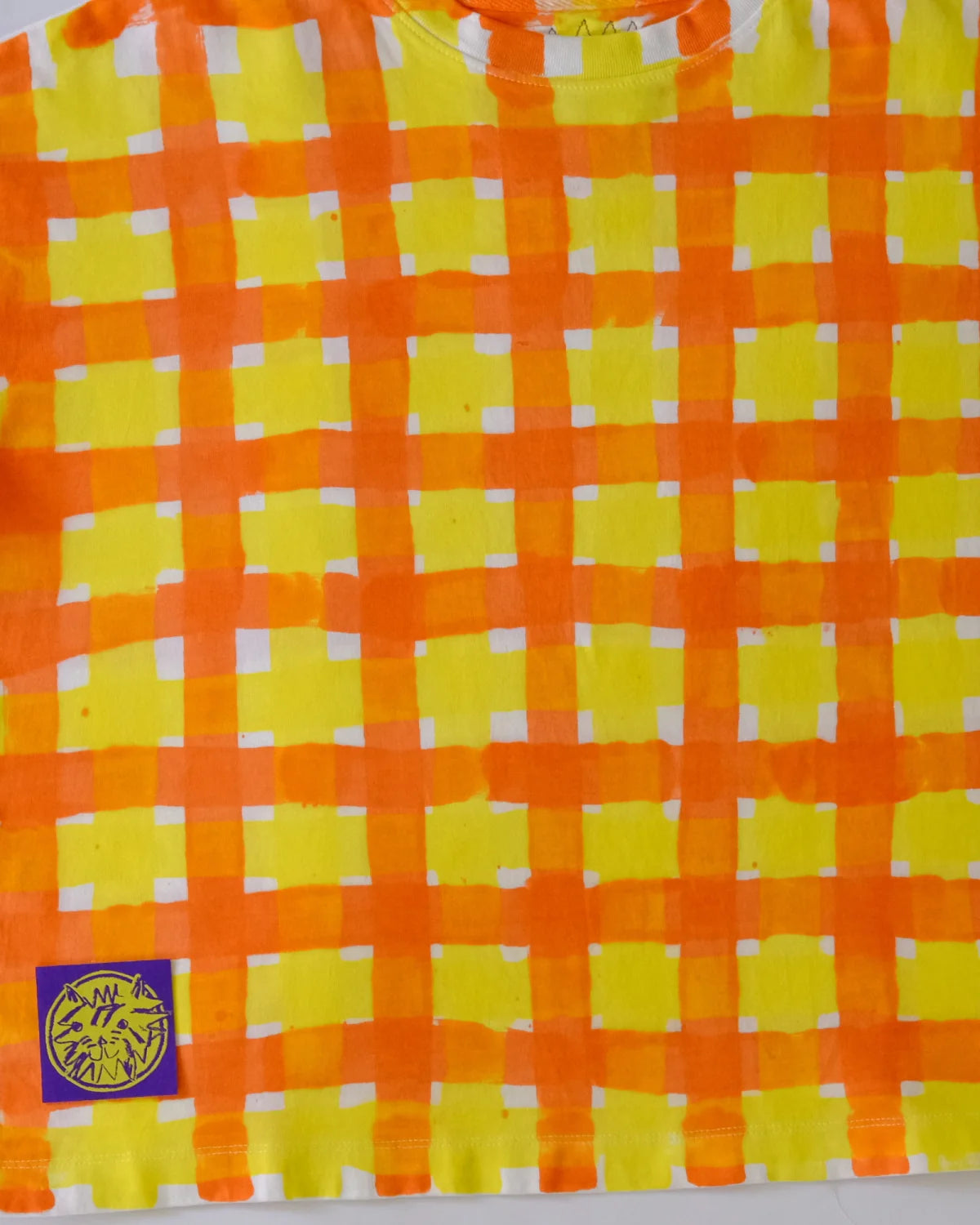 Close-up of hand-painted yellow and orange gingham